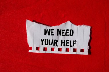We need your help message written on ripped torn paper background. Conceptual We need your help symbol. Copy space.