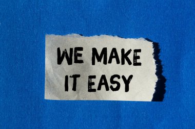 We make it easy message written on ripped torn paper background. Conceptual We make it easy symbol. Copy space.
