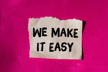 We make it easy message written on ripped torn paper background. Conceptual We make it easy symbol. Copy space.