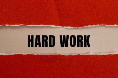 Hard Work message written on ripped torn paper background. Conceptual Hard Work symbol. Copy space.