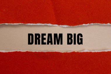 Dream Big message written on ripped torn paper background. Conceptual Dream Big symbol. Copy space.