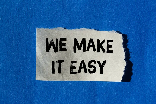 We make it easy message written on ripped torn paper background. Conceptual We make it easy symbol. Copy space.
