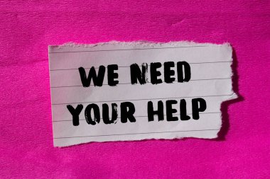 We need your help message written on ripped torn paper background. Conceptual We need your help symbol. Copy space.
