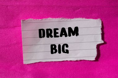 Dream Big message written on ripped torn paper background. Conceptual Dream Big symbol. Copy space.