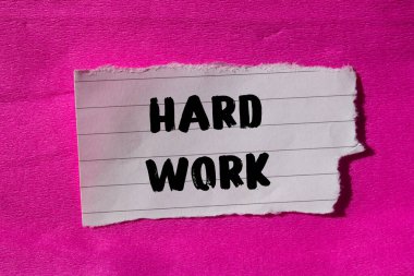 Hard Work message written on ripped torn paper background. Conceptual Hard Work symbol. Copy space.