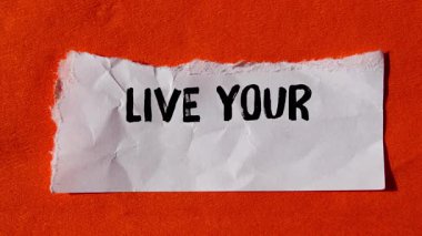 Live your values message writing on ripped torn paper background