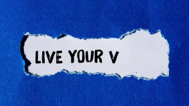 Live your values message writing on ripped torn paper background