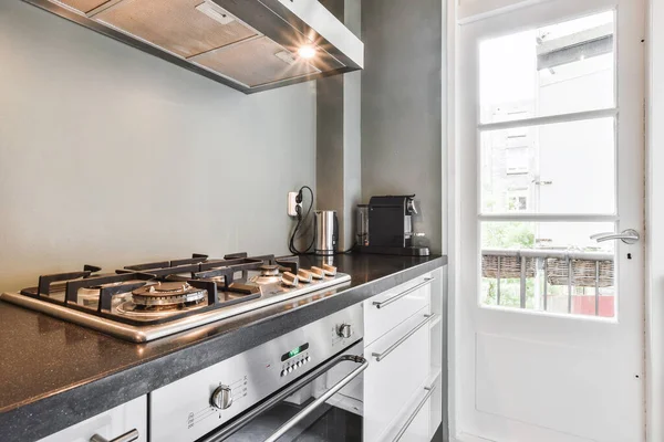 Kitchen appliances near balcony door