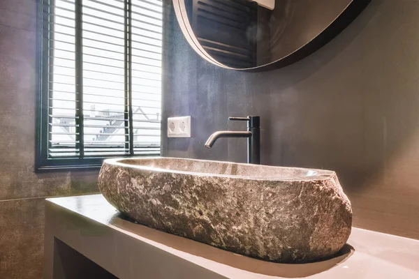 Modern stone vessel sink in bathroom