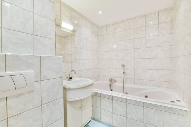 Lavabosu olan basit beyaz bir banyo.