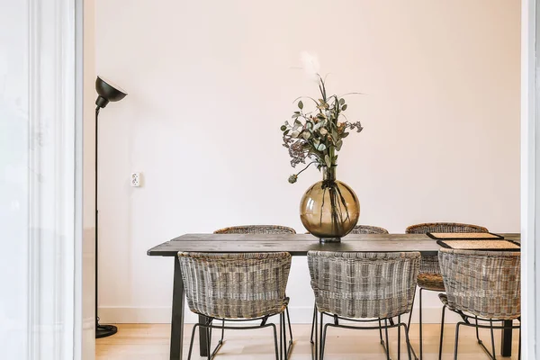 Florero con flores en la mesa en el comedor — Foto de Stock