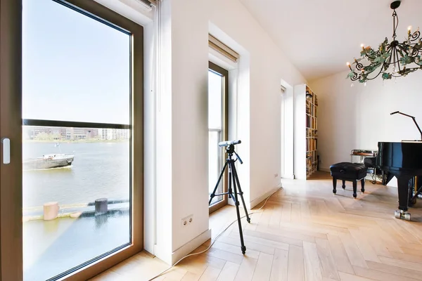 Living room with piano and telescope — Stock Photo, Image