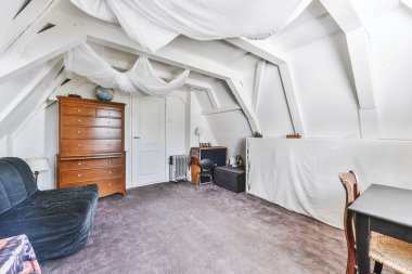 Tavan kirişli, kasvetli oda.