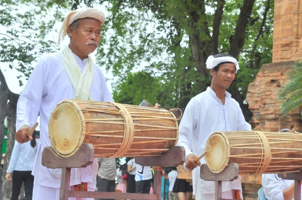 Nha Trang, Vietnam - July 11, 2015: Two old men are performing the traditional drums technique of champa at the Po Nagar temple in Nha Trang