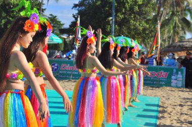 Nha Trang, Vietnam - July 14, 2015: Young girl dancers are performing a sport dance on the beach of Nha Trang city clipart