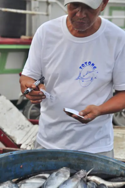 General Santos, Filipinas - 5 de setembro de 2015: Pescador está contando atum de barco de pesca no porto — Fotografia de Stock