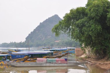 Quang Binh, Vietnam - 23 Ekim 2015: geleneksel yerel tekne turizm için transfer seyahat edenler için bekleyen bir iskelede demirleme