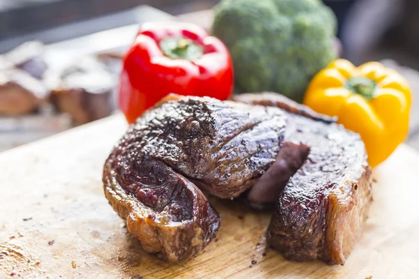 Carne frita na tábua de corte com pimenta — Fotografia de Stock