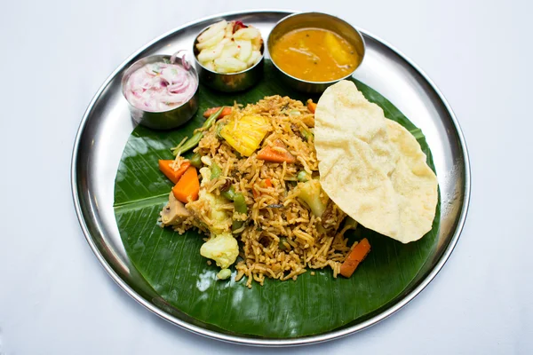 Indian vegetarian food with fried rice on banana leaf tray — Stock Photo, Image