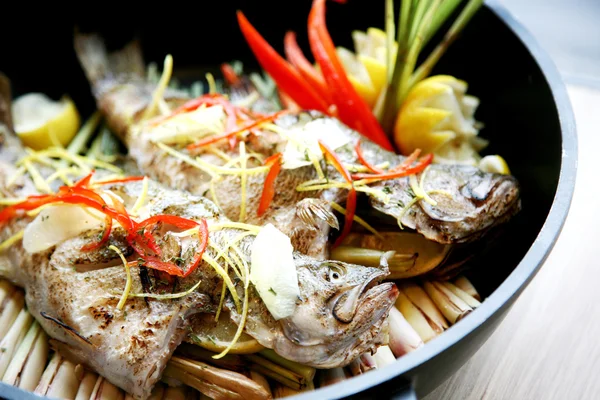 Steamed grouper in Japanese style on plate in restaurant