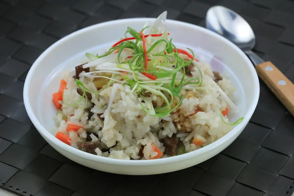 Nasi goreng spesial dengan daging babi dan herbal di atas mangkuk putih di atas meja — Stok Foto
