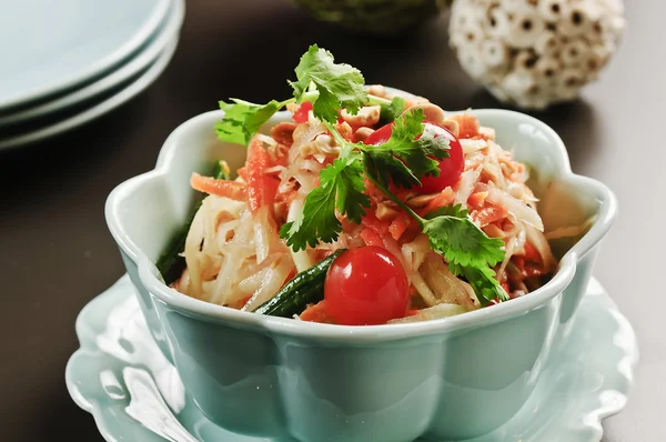 Special salad with tomato and herbs in white bowl