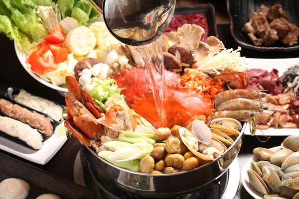 Supper crab hot pot with mushroom, clams, shrimps, corn and vege — Stock Photo, Image