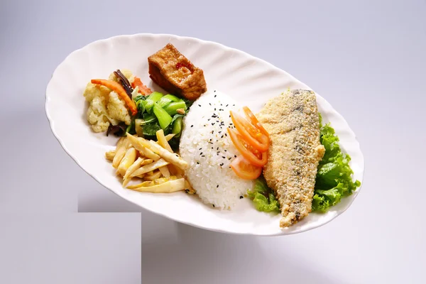 Nasi steak ikan goreng dengan sayuran di piring putih di bac putih — Stok Foto