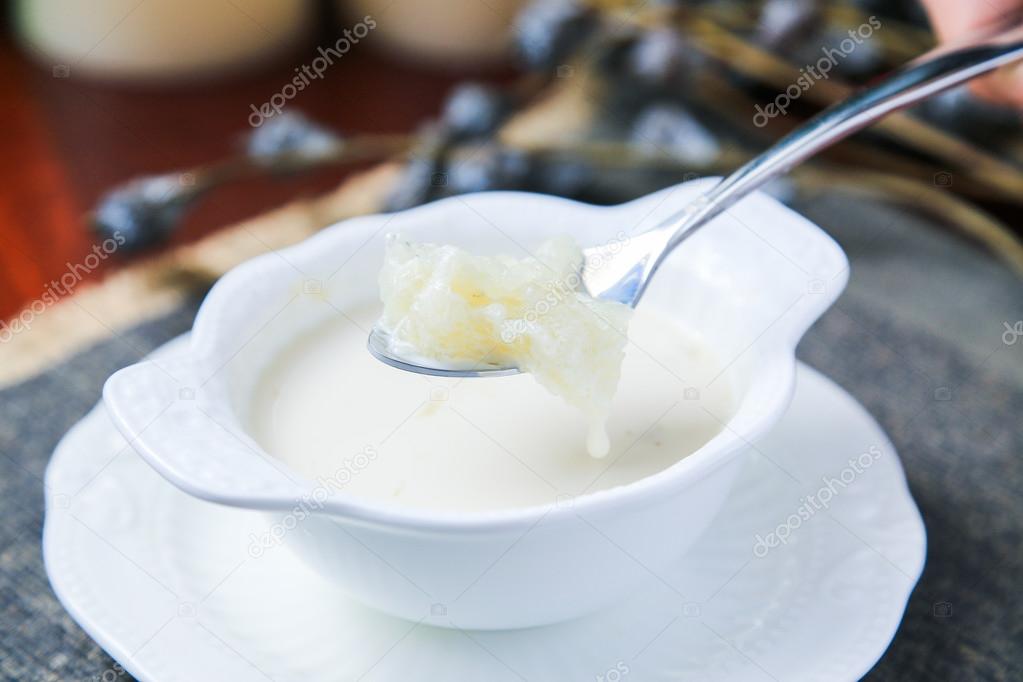 Sweet soup of salanganes or bird's nest in a white cup in asia