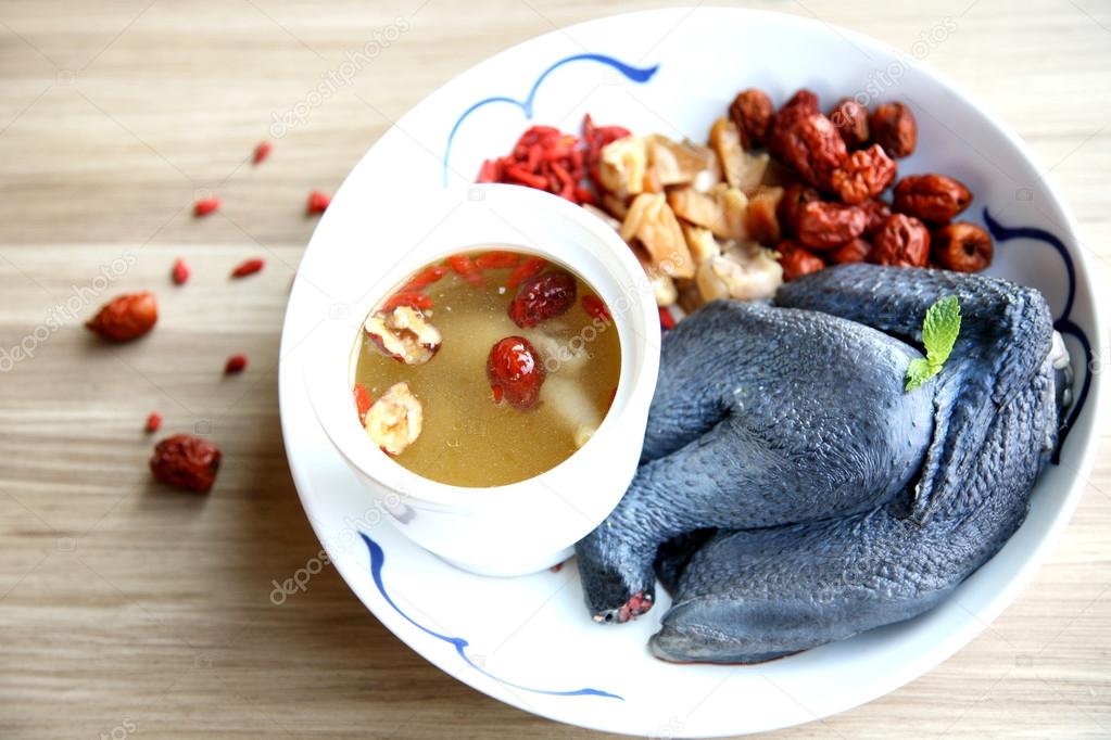 Double boiled chicken soup in Chinese style in white plate