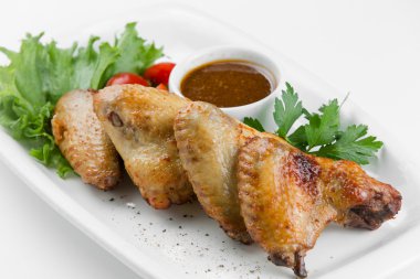 Beyaz tabakta baharatlı Soya soslu kızarmış tavuk kanadı
