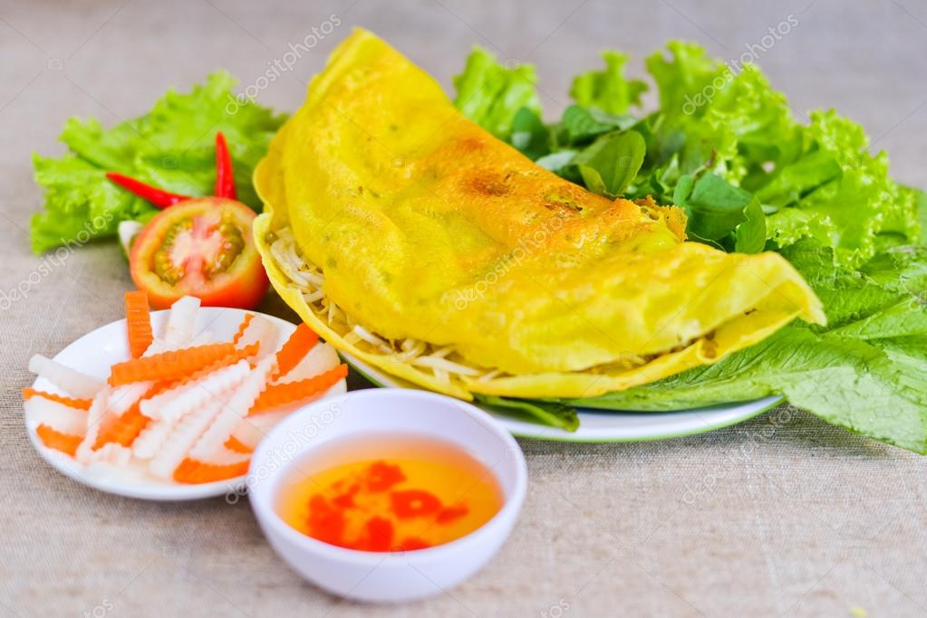 Vietnamese rice pancake with fish sauce, tomato and fermented ca ...