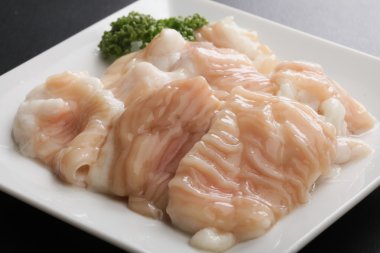 Fresh raw pig hormone stomach Intestine on white platter clipart