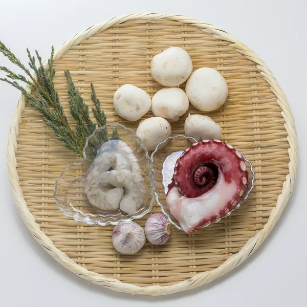 Fresh raw octopus and shrimp with mushroom and onion on bamboo t — Stock Photo, Image