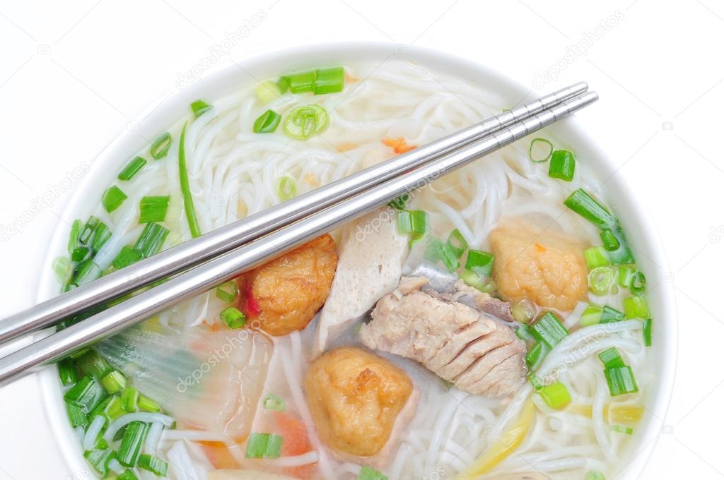Bun cha ca or Vietnamese rice vermicelli with grilled fish and herbs on a white background