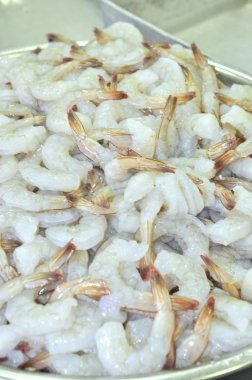 Tra Vinh, Vietnam - November 19, 2012: Peeled shrimps are about being put into the frozen machine in a seafood factory in the mekong delta of Vietnam