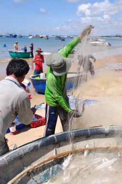 Lagi, Vietnam - 26 Şubat 2012: Yerel balıkçılar balıkları Lagi Beach balıkçılık ağları kaldırdığınızı