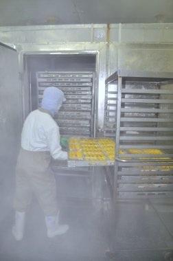 Ho Chi Minh city, Vietnam - October 3, 2011: Workers are working hard in a cold environment in a seafood factory in Ho Chi Minh city, Vietnam clipart