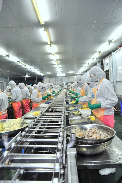 Ho Chi Minh city, Vietnam - October 3, 2011: Workers are working hard on a production line in a seafood factory in Ho Chi Minh city, Vietnam — Stock Photo, Image