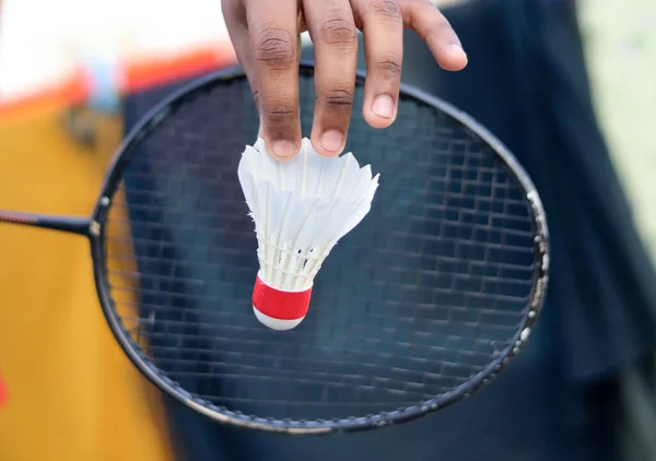 Badminton player holding racket with Badminton Shuttlecock.