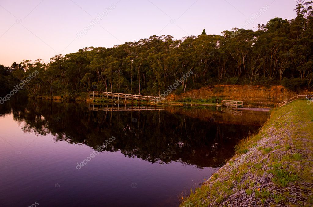 Lake With Wooden Walkway at Dusk