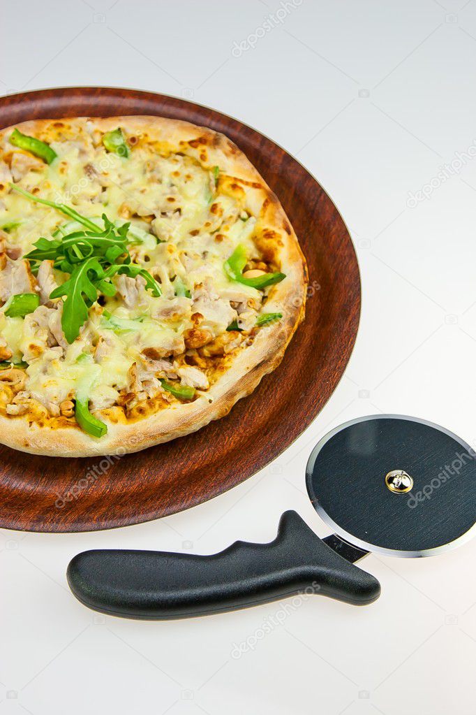 Chicken Pasta on Tray and Pizza Cutter on white