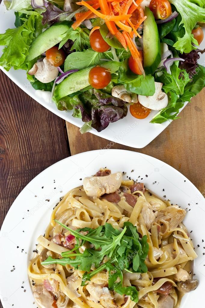 Chicken Pasta and Vegetable Salad Meal on Table