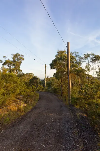 Australian Dirt Road with Electric Poles in Sunset — Stock Photo, Image