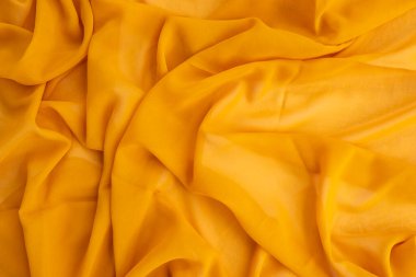 Minimalist Kavram. Sarı eşarp dokusu arka planı. Sonbahar, sonbahar konsepti. Düz konum, üst görünüm, boşluğu kopyala