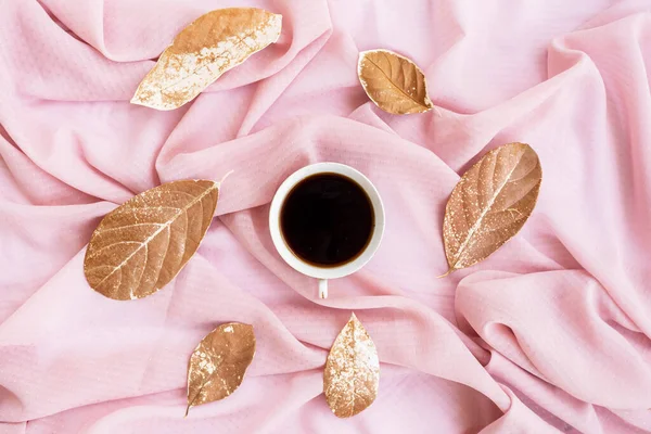 Minimalist Concept. Coffee and dry leaves On Brown Scarf Background.Autumn, autumn concept. Flat lay, top view, copy spac