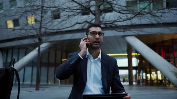 Smíšené závod podnikatel chatování na mobilní zařízení s úsměvem při obědě přestávka v práci — Stock video
