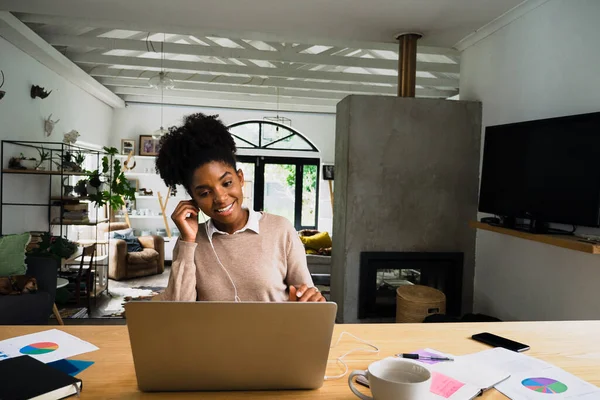 Beautiful young female working from home, on a business video call during covid19, lockdown — стоковое фото