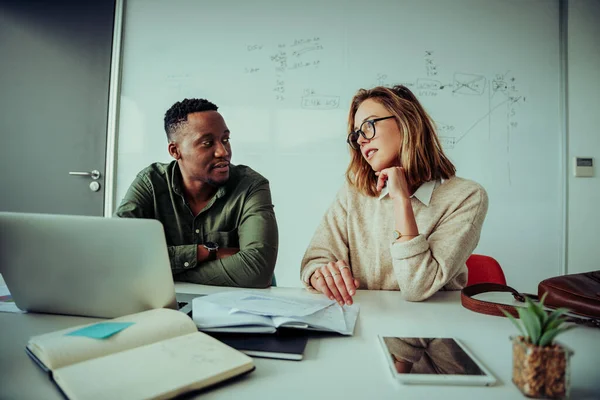 Male and female partners brainstorming ideas for new business discussing project plans in board room during team meeting — 图库照片