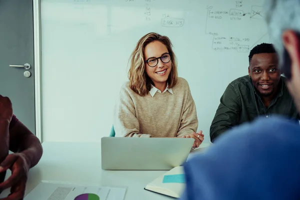 Smiling business woman feeling proud of clients ideas on improving business recovery from pandemic sitting around table during conference meeting — 图库照片